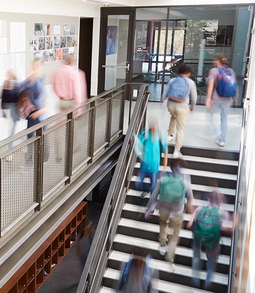 Students climbing stairs at university